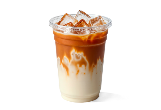 Iced coffee with a gradient of white to brown in a clear plastic cup on a white background